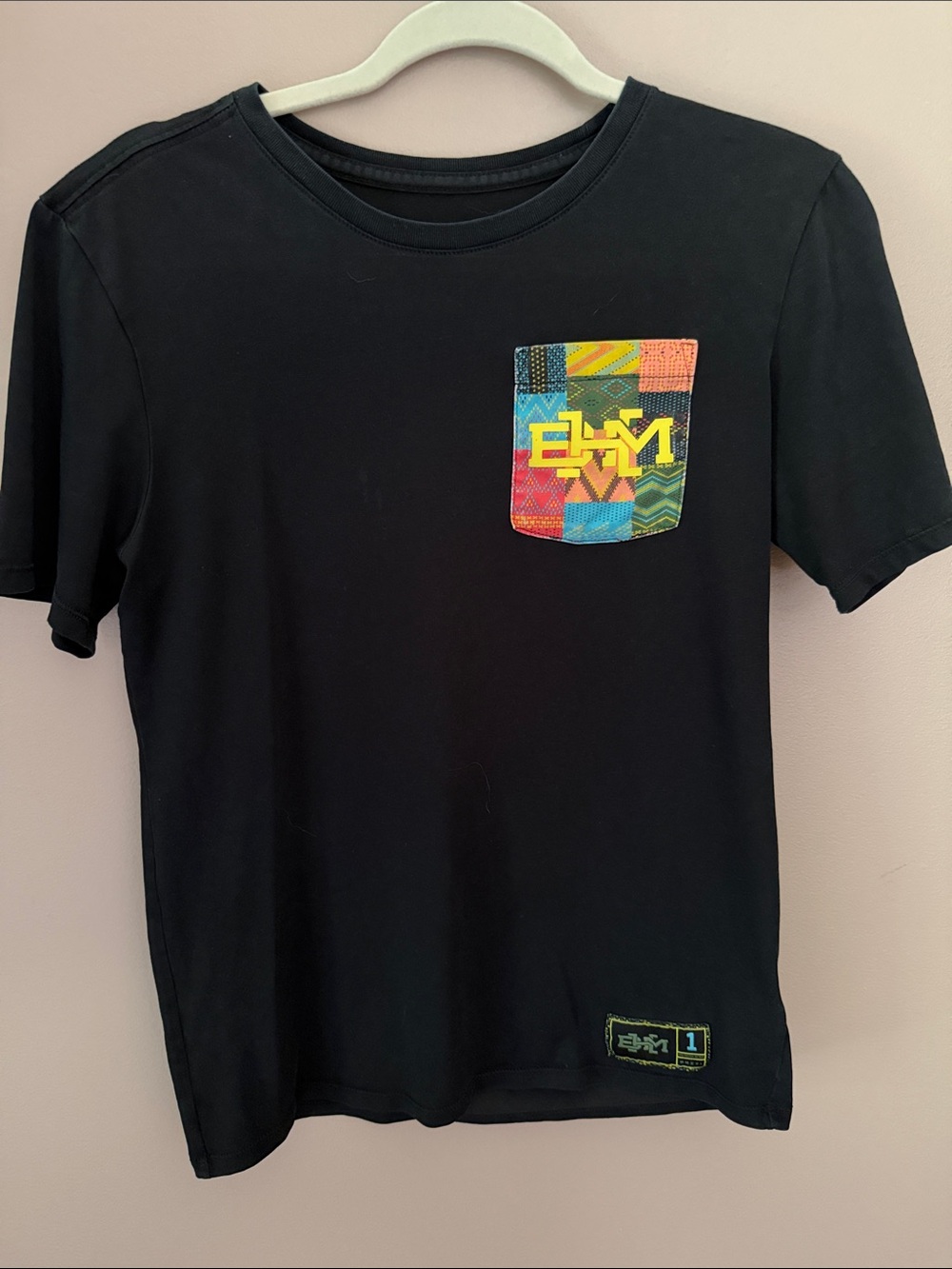 Nike Black Short Sleeve Tee with Multicolor Chest Pocket. Black History Month
